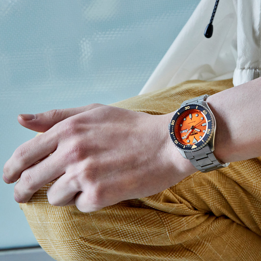 A Man Wearing Seiko 5 Sports Automatic Watch SRPD59K1 with Orange Dial