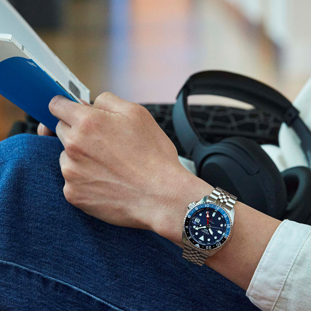 Man Wearing Seiko 5 Sports Blueberry GMT SKX Re-Interpretation Watch SSK003K1 Reading Book